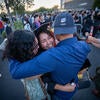 Graduate hugging guests